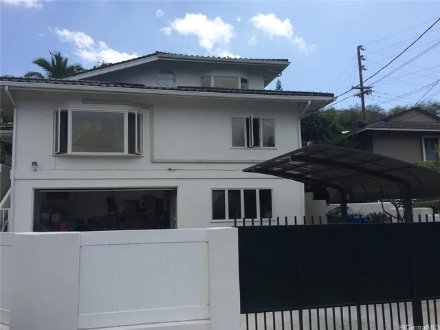 a front view of a house with a parking space