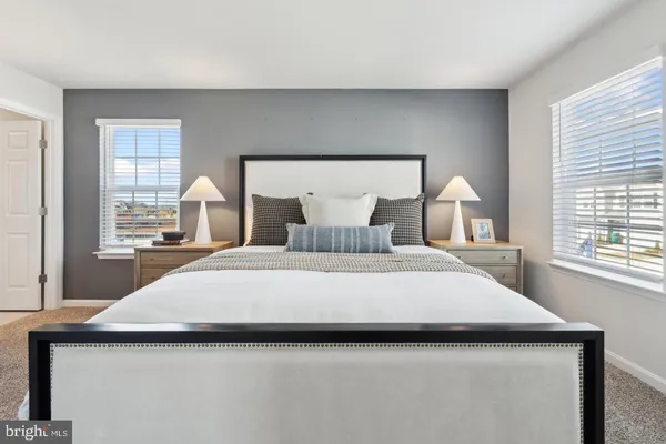 a spacious bedroom with a bed and a window