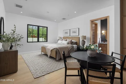 a bedroom with a large bed and a table