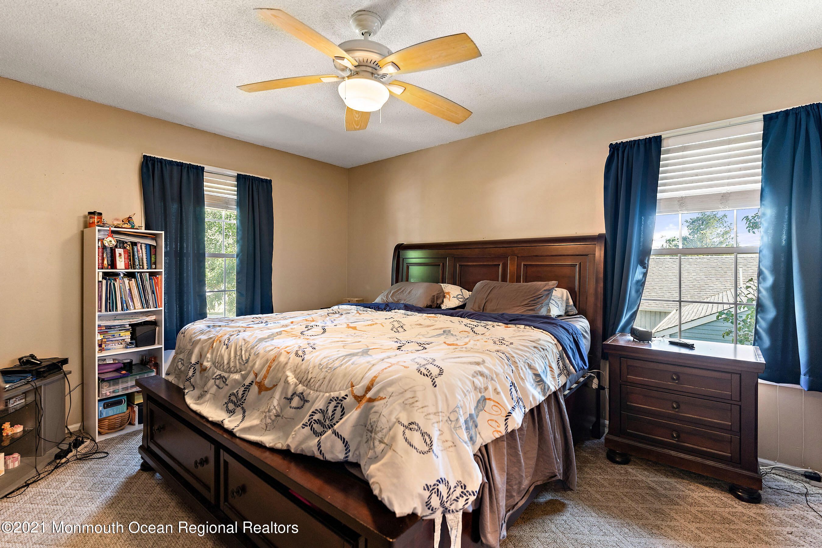 72 Reflection Road Toms River, NJ 08753 - Photo 21 of 31 a bedroom with a large bed and a chandelier