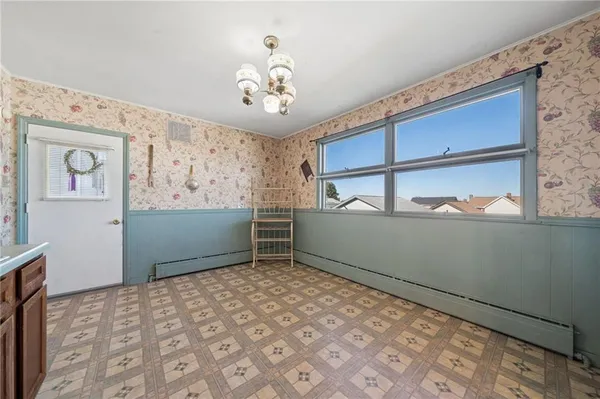 a view of a room with wooden floor and windows