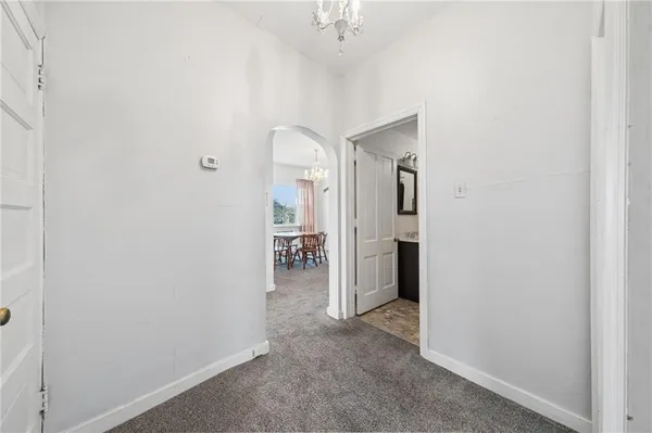 a view of a hallway with wooden shelves