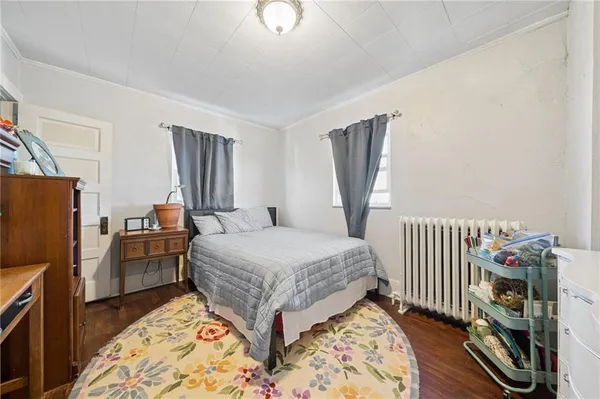 a bedroom with a bed and flat screen tv