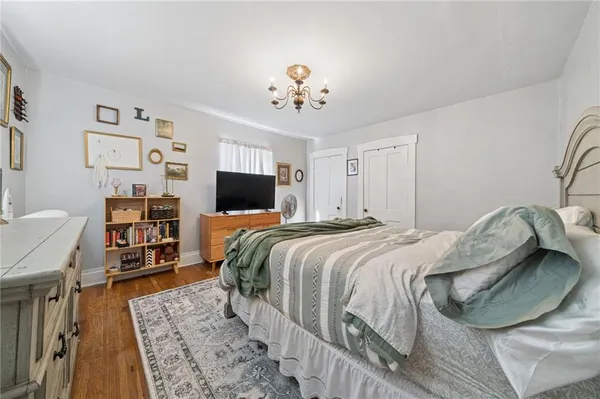 a bedroom with a bed and a chandelier