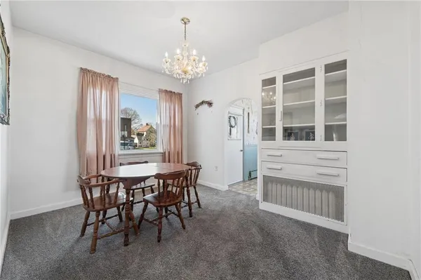 a view of a dining room with furniture and chandelier