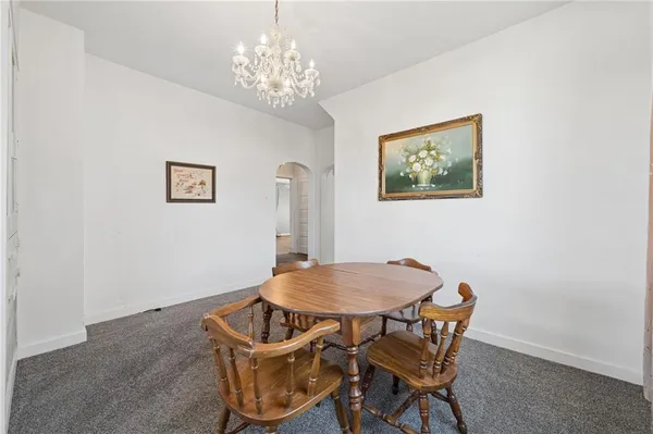 a view of a dining room with furniture and chandelier