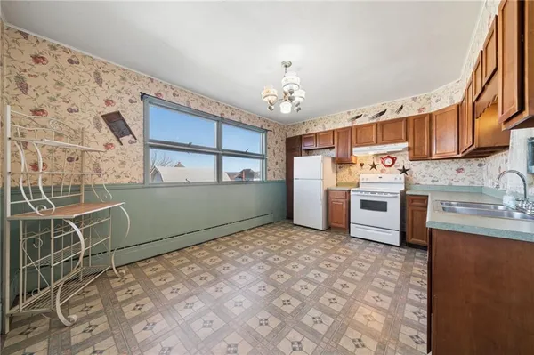 a kitchen with stainless steel appliances a sink and cabinets