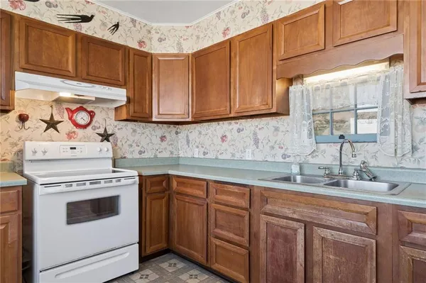 a kitchen with a sink stove and cabinets