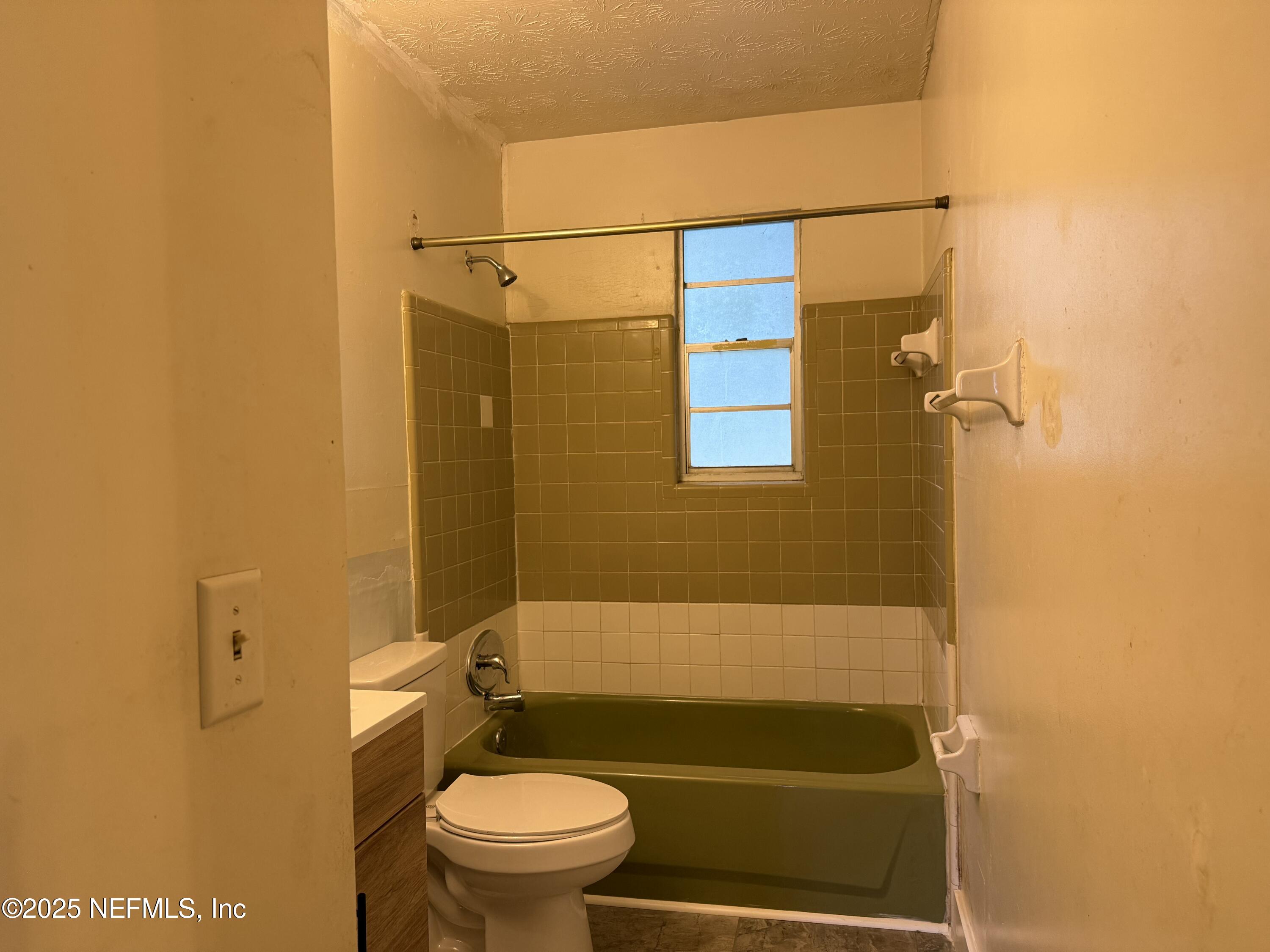 679 James Court Macclenny, FL 32063 - Photo 12 of 17 a bathroom with a shower a toilet and sink