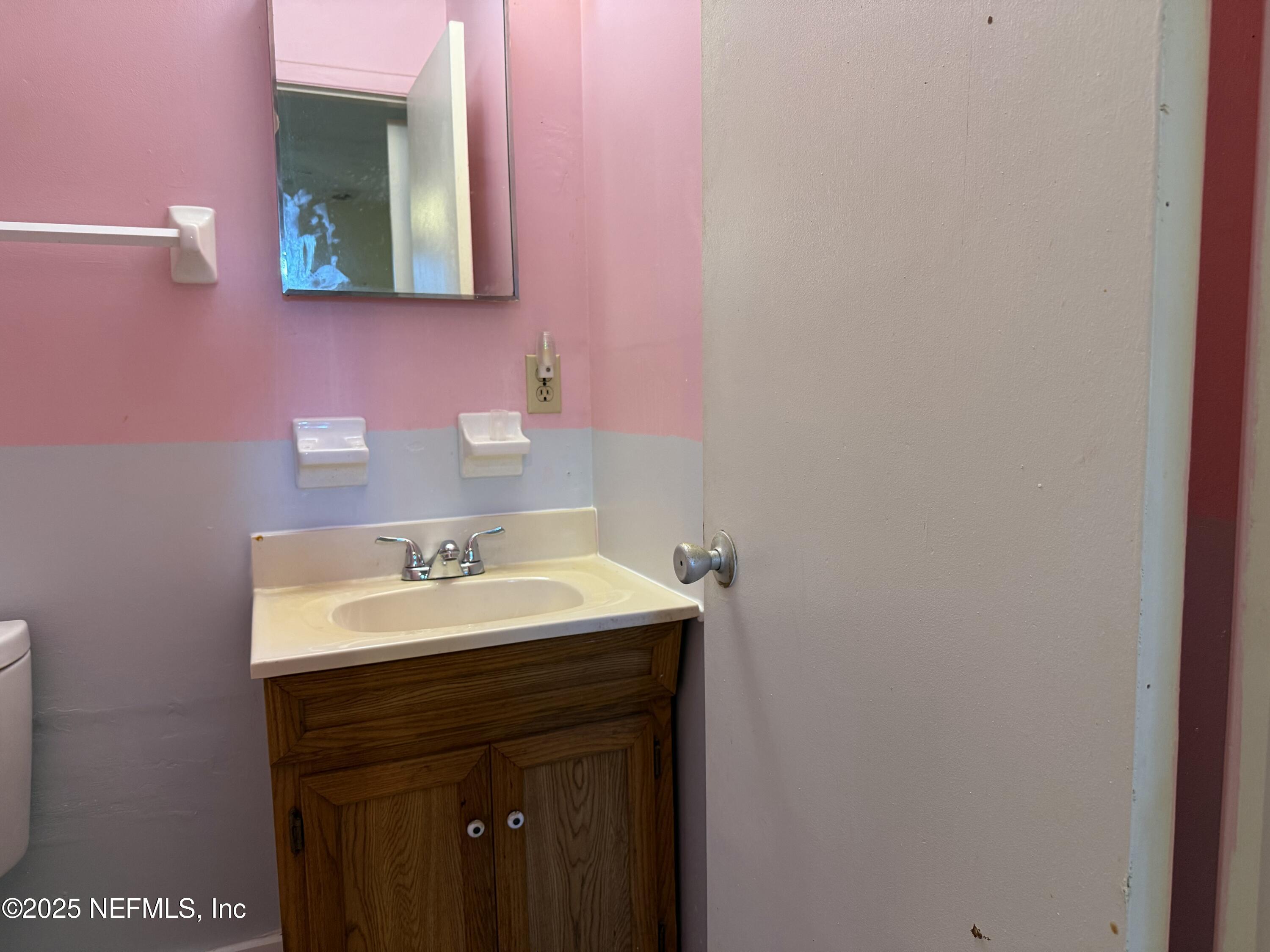 679 James Court Macclenny, FL 32063 - Photo 15 of 17 a bathroom with a sink vanity and a mirror