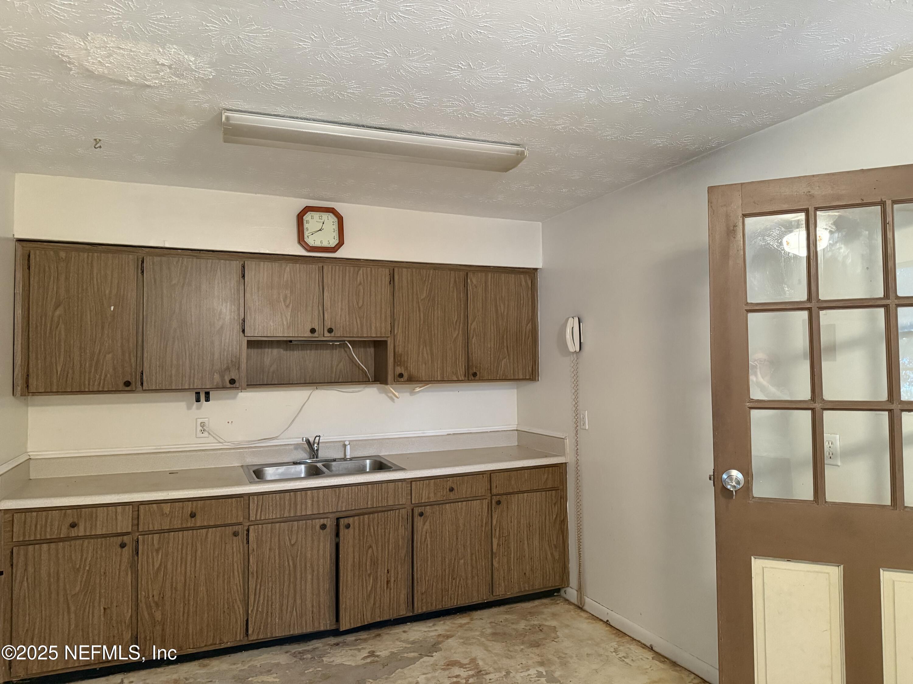 679 James Court Macclenny, FL 32063 - Photo 7 of 17 a kitchen with granite countertop a sink and a stove