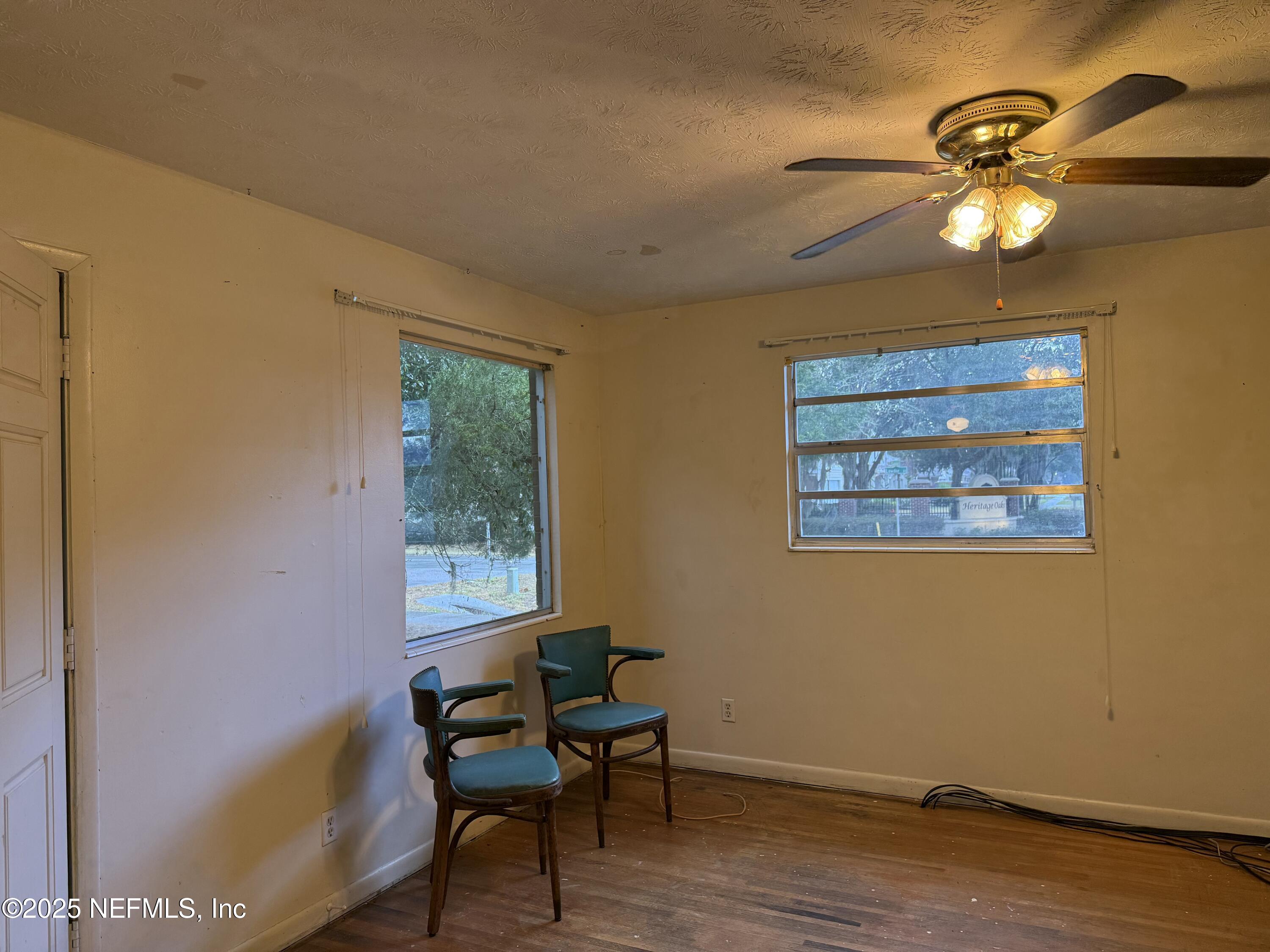 679 James Court Macclenny, FL 32063 - Photo 9 of 17 a view of a workspace room with wooden floor windows and lounge chair