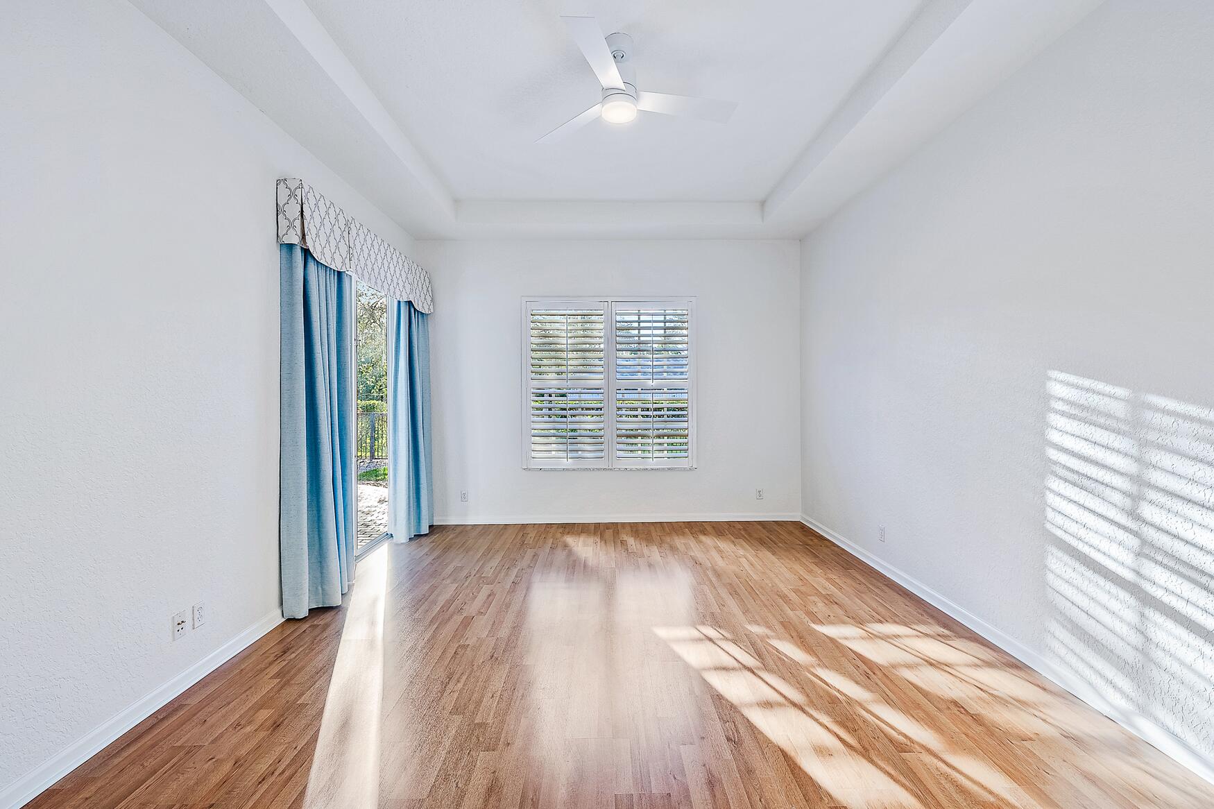 116 Via Rosina Jupiter, FL 33458 - Photo 15 of 33 a view of an empty room with wooden floor and a window