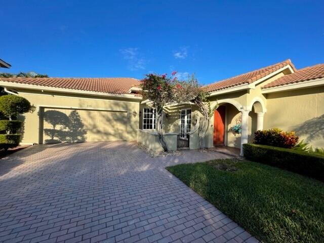 116 Via Rosina Jupiter, FL 33458 - Photo 2 of 33 a view of a street with a building in the background
