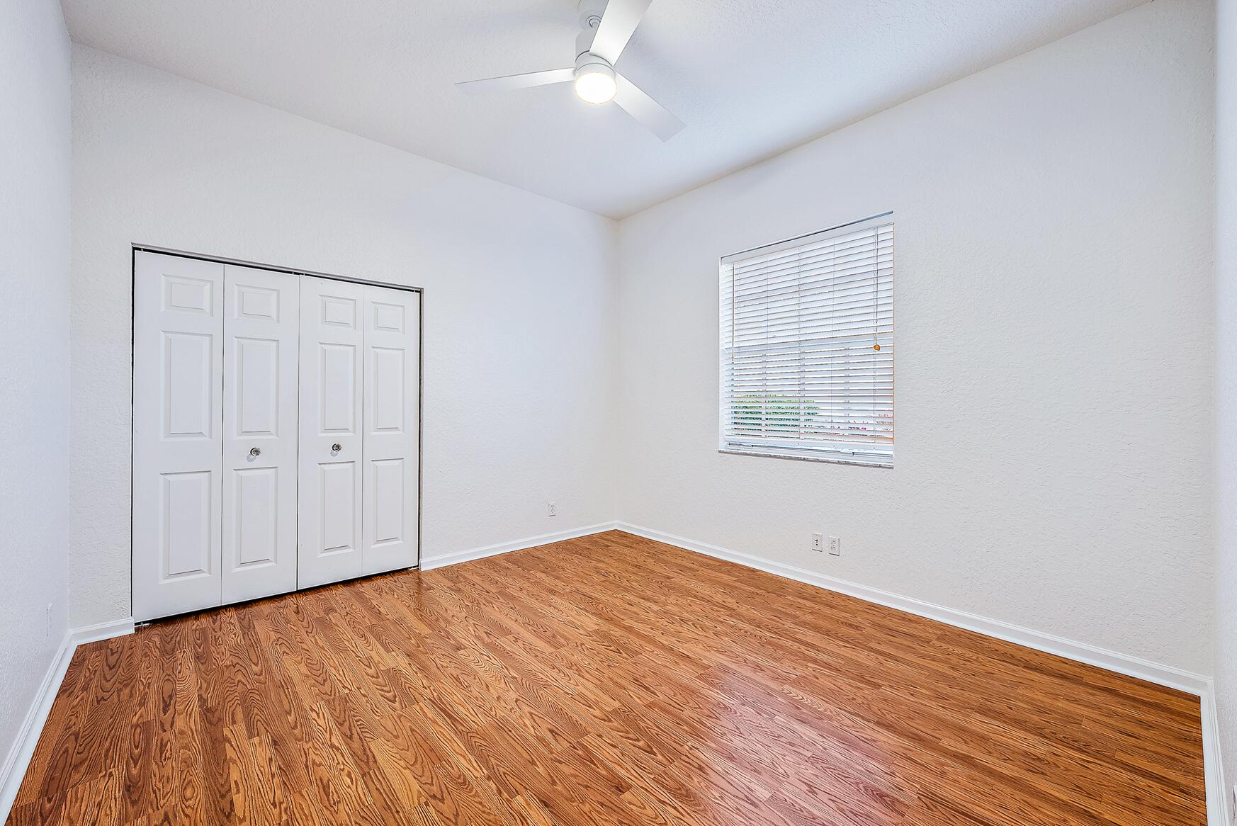 116 Via Rosina Jupiter, FL 33458 - Photo 21 of 33 a view of empty room with wooden floor and fan
