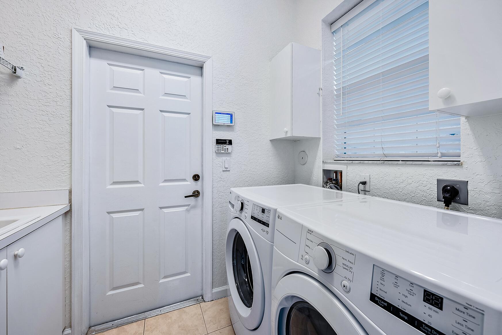 116 Via Rosina Jupiter, FL 33458 - Photo 23 of 33 a utility room with dryer and washer