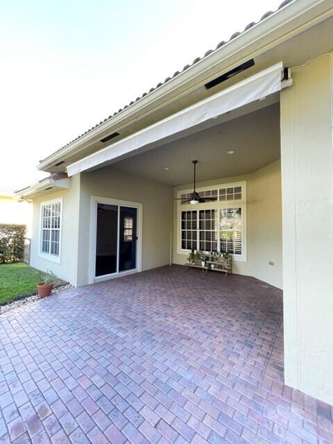 116 Via Rosina Jupiter, FL 33458 - Photo 24 of 33 front view of a house with a large window and a yard
