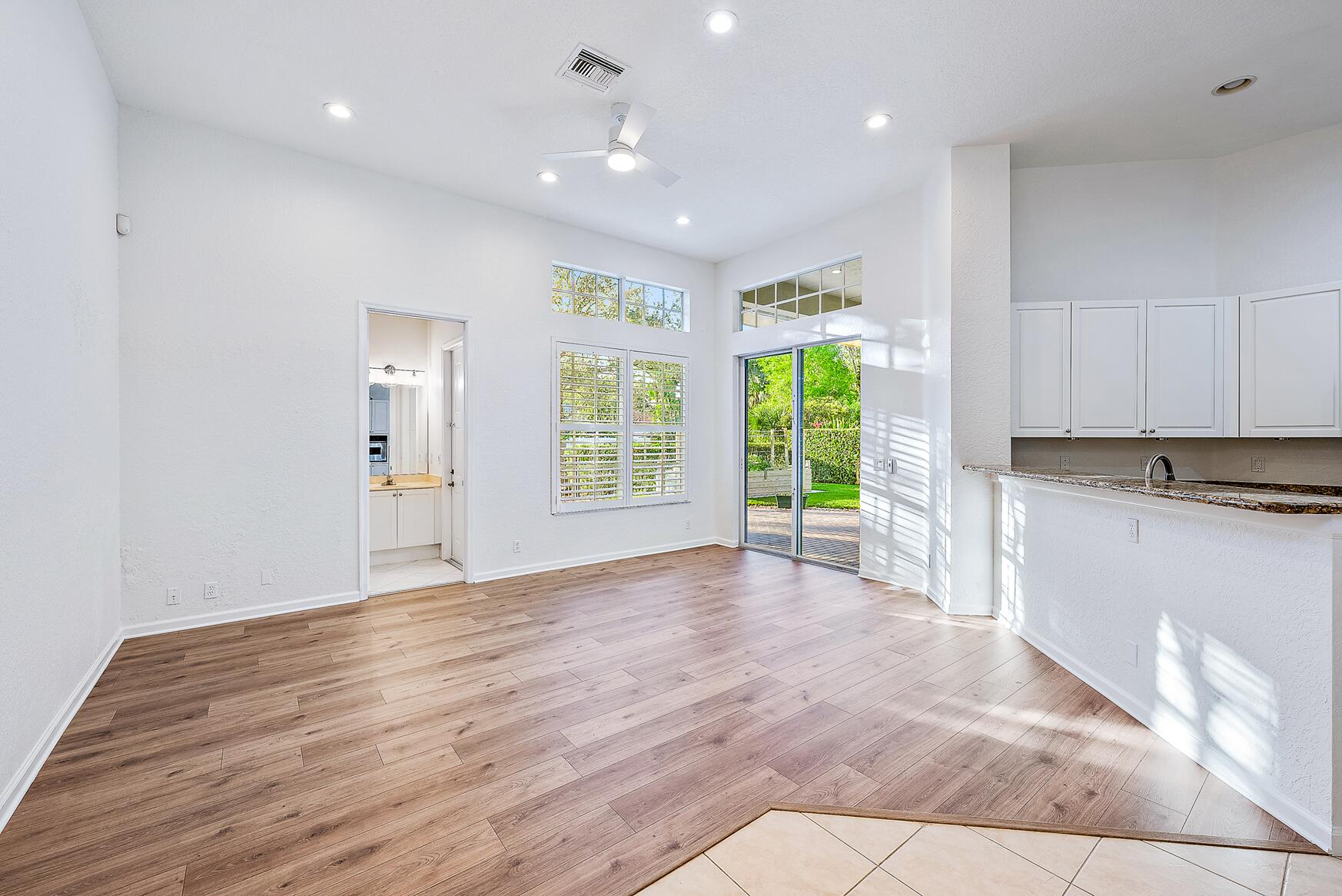 116 Via Rosina Jupiter, FL 33458 - Photo 6 of 33 a view of an empty room with wooden floor and a window