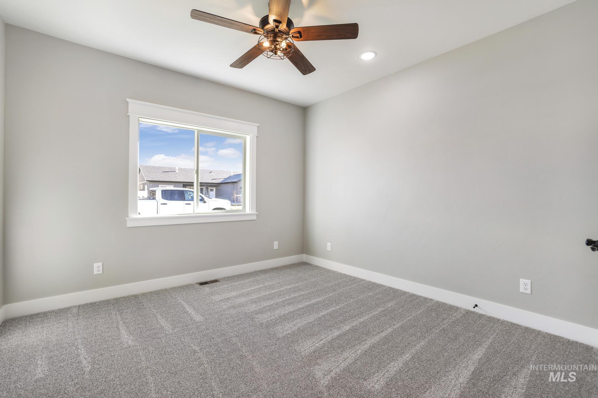 298 Sandi Road Twin Falls, ID 83301 - Photo 21 of 24 Room with neutral-toned walls, gray textured carpeting, and white baseboards