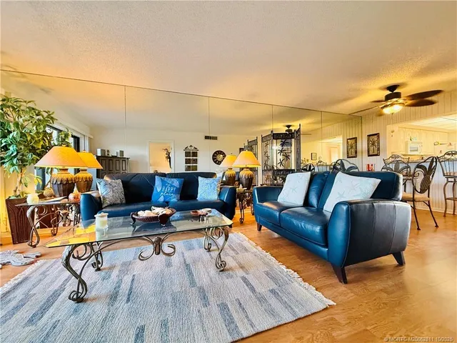 a living room with lots of furniture and wooden floor