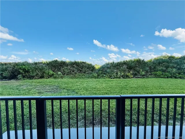 a view of a city and lush green forest