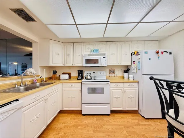 a kitchen with cabinets appliances and a counter space