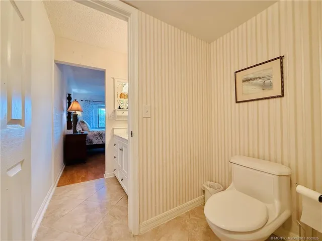 a en suite bathroom with a granite countertop sink and a mirror