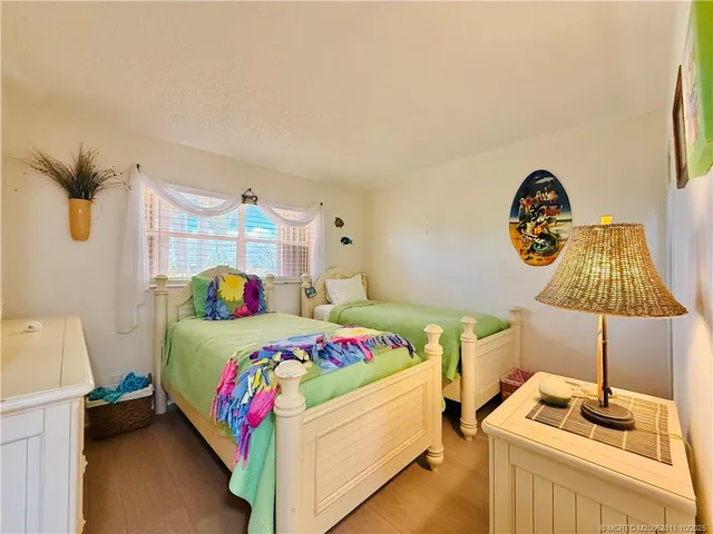 a bedroom with two beds and a window