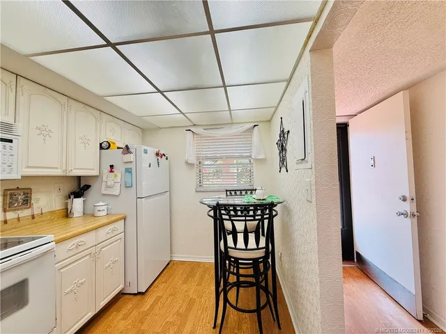 a kitchen with stainless steel appliances a refrigerator and microwave