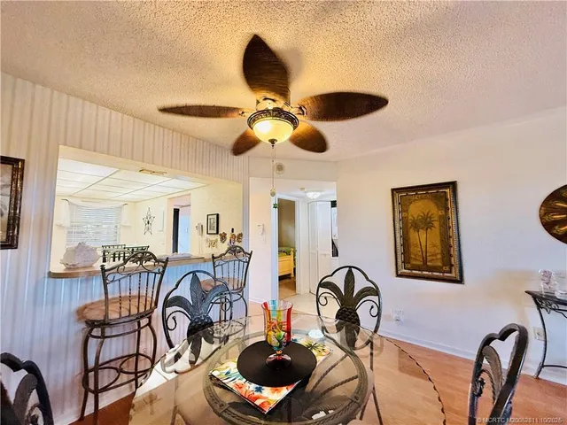 a view of a dining room with furniture a chandelier and wooden floor
