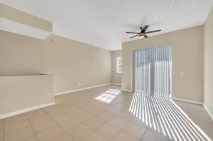 a view of an empty room with closet and a window