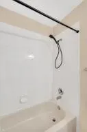 a bathroom with a glass shower door