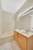 a bathroom with a sink double vanity and a mirror