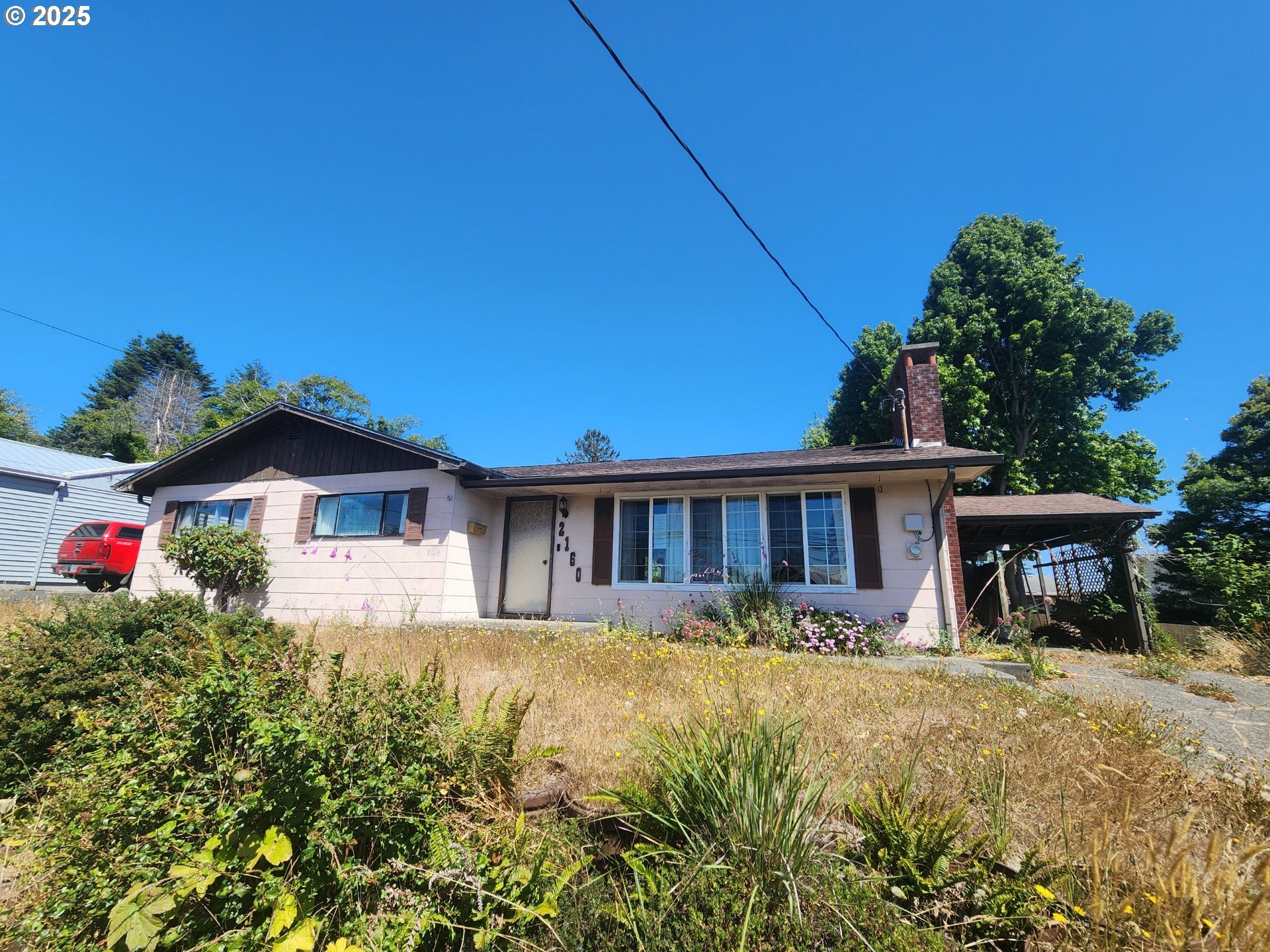 2160 Lombard Street North Bend, OR 97459 - Photo 1 of 1 a view of a house with a yard and potted plants