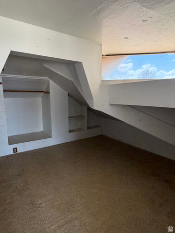 255 E Centre Spring City, UT 84662 - Photo 23 of 34 Room featuring a built-in storage niche with shelving, a closet area with a clothes rod, and a horizontal window
