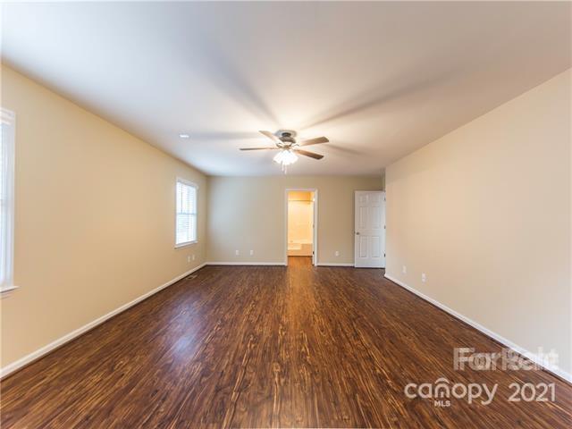 1347 Mistletoe Ridge Place Northwest Concord, NC 28027 - Photo 18 of 34 a view of an empty room with wooden floor and a window