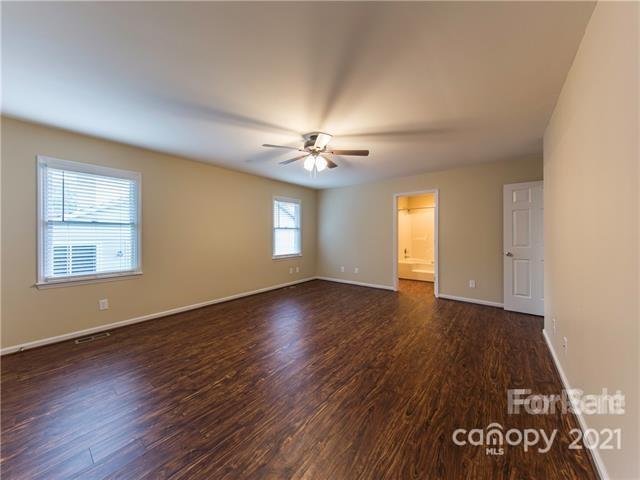 1347 Mistletoe Ridge Place Northwest Concord, NC 28027 - Photo 19 of 34 a view of an empty room with a window and wooden floor