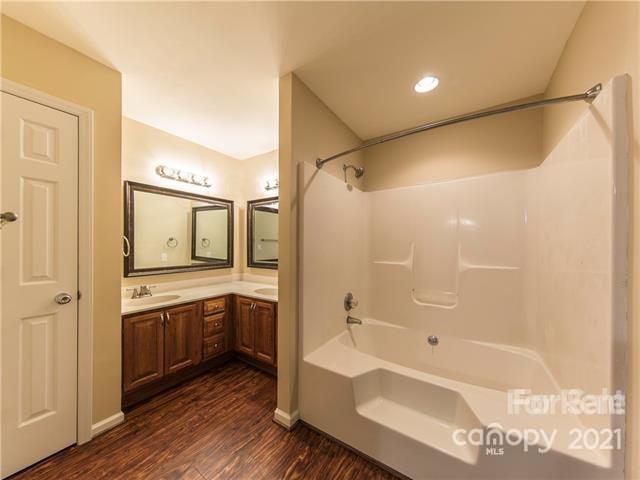1347 Mistletoe Ridge Place Northwest Concord, NC 28027 - Photo 20 of 34 a spacious bathroom with a granite countertop tub sink shower and mirror