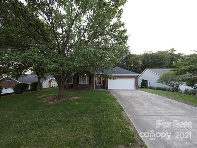 1347 Mistletoe Ridge Place Northwest Concord, NC 28027 - Photo 2 of 34 a front view of a house with a garden and trees