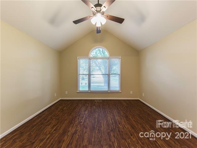1347 Mistletoe Ridge Place Northwest Concord, NC 28027 - Photo 22 of 34 a view of an empty room with a window and wooden floor