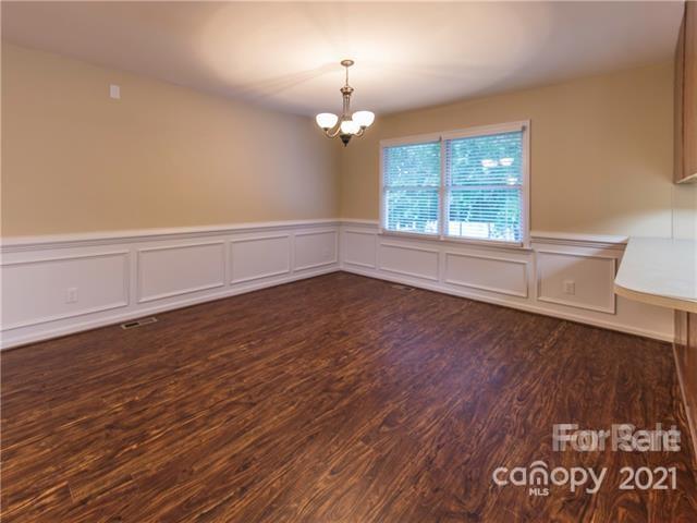 1347 Mistletoe Ridge Place Northwest Concord, NC 28027 - Photo 9 of 34 wooden floor in an empty room with a window