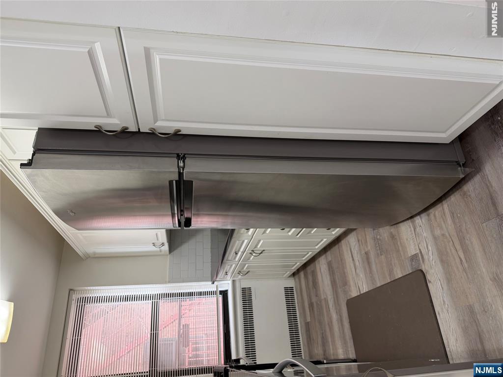 100 Prospect Avenue, Unit 2E Hackensack, NJ 07601 - Photo 11 of 16 a kitchen with a refrigerator and a window