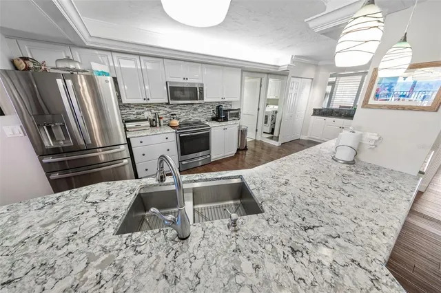 a kitchen with a refrigerator sink and stove