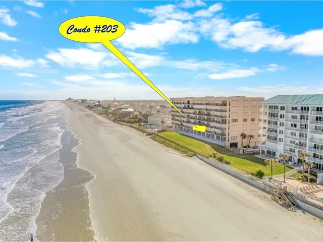a bedroom with a bed flat screen tv and a large mirror