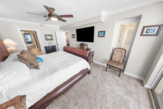 a bedroom with a bed and a ceiling fan