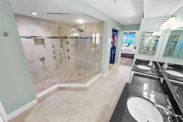 a bathroom with a sink a toilet a mirror and shower