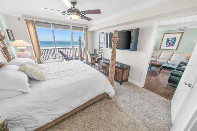 a bedroom with two beds and a chandelier