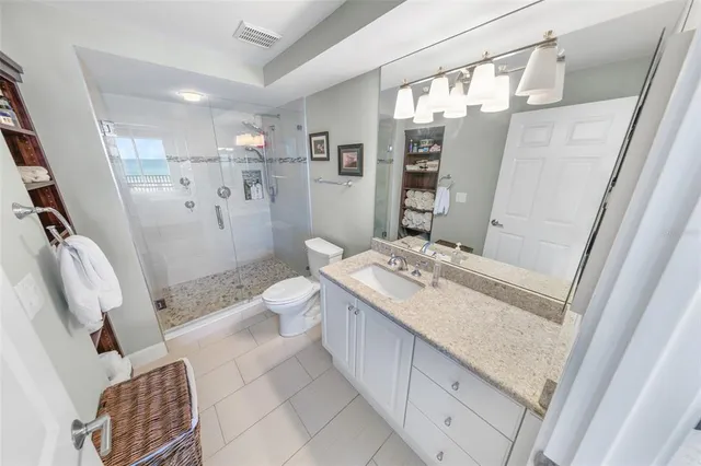 a bedroom with two beds and a chandelier