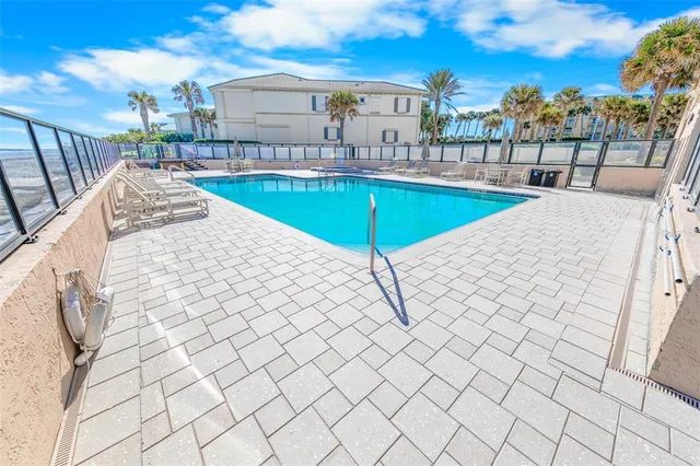 a view of a patio with swimming pool table and chairs