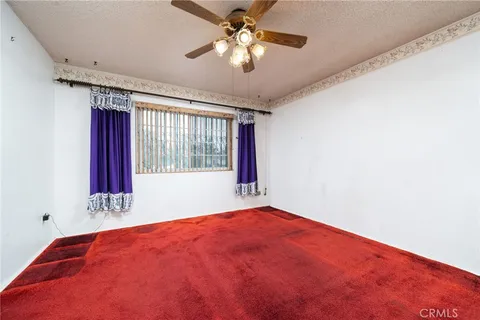 a view of a room with window and a ceiling fan